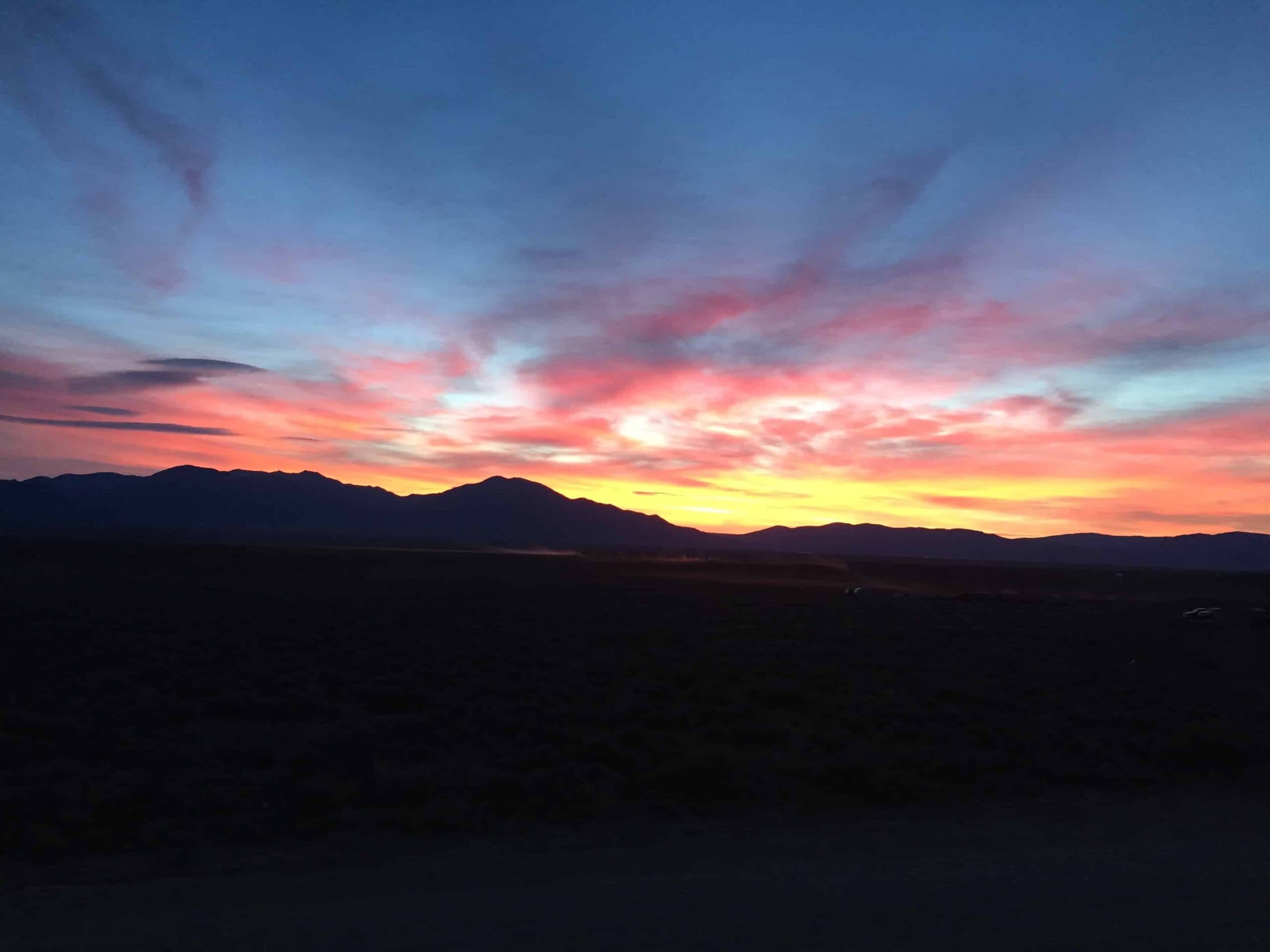 Serene sunset over mountains symbolizing harmony and mindfulness for planetary healing and holistic well-being.