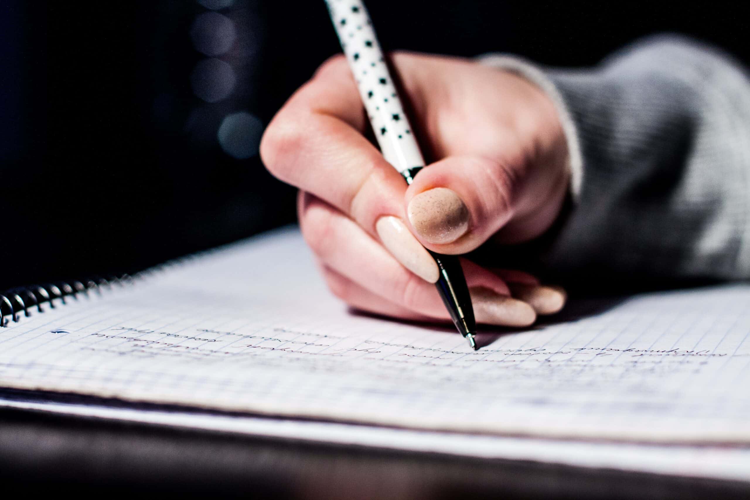 woman hand writing on a notebook
